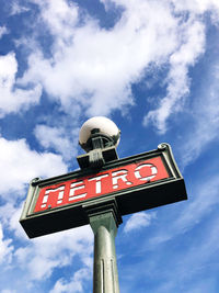 Low angle view of road sign against sky