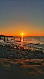 Scenic view of beach against sky during sunset