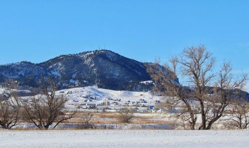 Scenic view of snowcapped mountains against clear sky