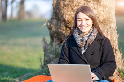 Portrait of young woman using laptop