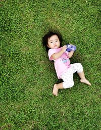 High angle view of woman lying on grass