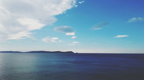 Scenic view of sea against cloudy sky