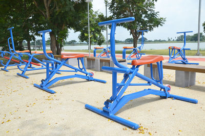 Blue exercise bikes by lake