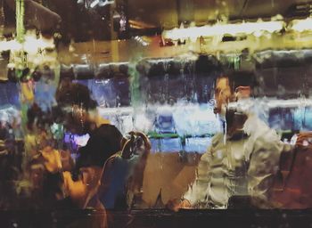 Rear view of people sitting in store