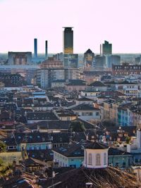 High angle view of buildings in city against clear sky