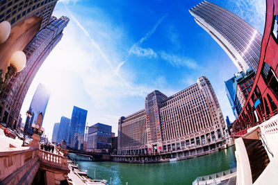 Low angle view of modern buildings in city against sky