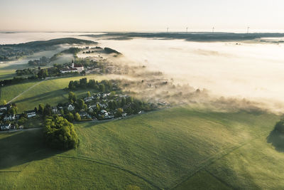 Germany, bavaria, berg, aerial view of countryside village at foggy springtime dawn