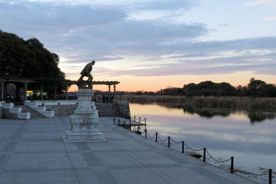 Scenic view of lake against sky during sunset