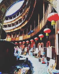 Illuminated lanterns hanging in building