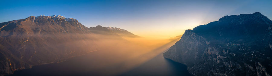 Scenic view of snowcapped mountains against sky during sunset