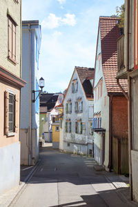 Street amidst buildings against sky