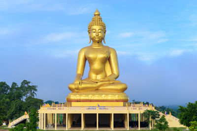 Low angle view of statue against temple against sky