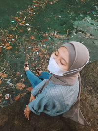 High angle view of woman sitting in park