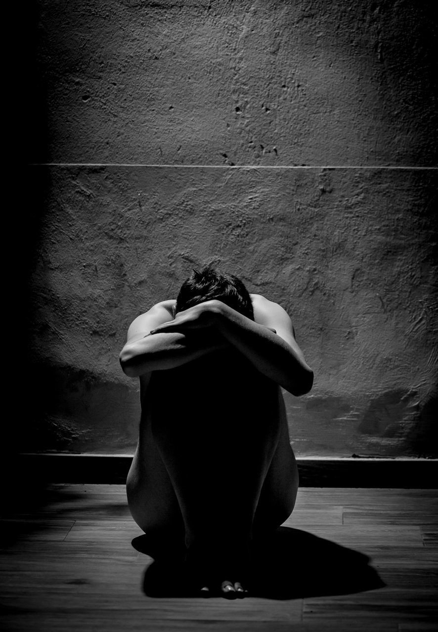 black, white, darkness, black and white, light, monochrome, monochrome photography, wall - building feature, shadow, sitting, indoors, one person, wall, clothing