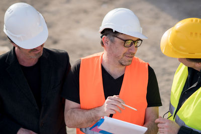 Construction workers communicating at site