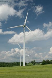 Windmill on field against sky