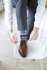 Low section of man wearing shoes