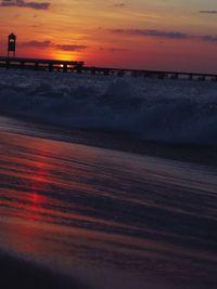 Scenic view of sea against orange sky