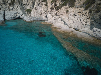 High angle view of rock formation by sea