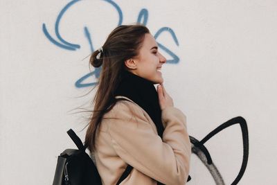 Young woman looking away against white background