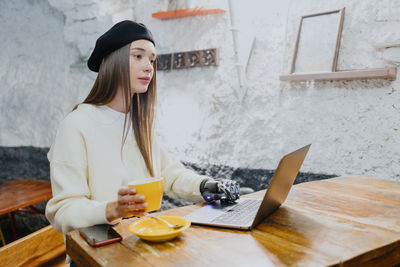 Portrait of young woman using mobile phone