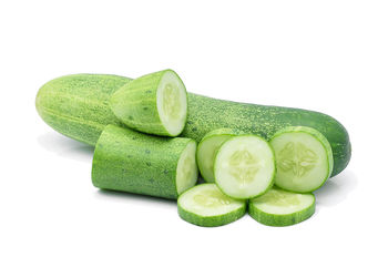 Close-up of cucumber slices against white background