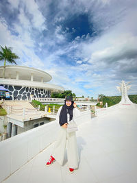 Portrait of woman standing against sky