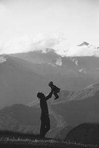 Man standing on mountain against sky