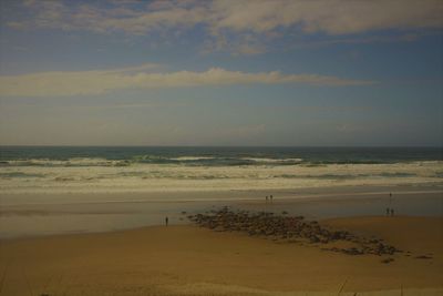 Scenic view of beach against sky during sunset