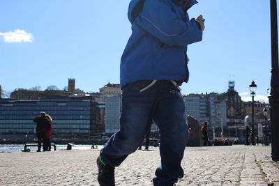 Rear view of a woman standing in city