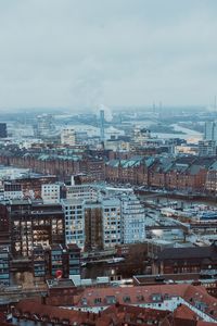 Aerial view of townscape against sky during winter