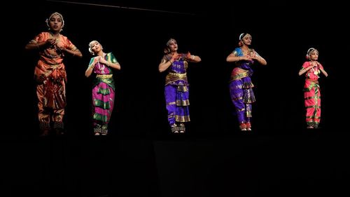 High angle view of people standing against black background