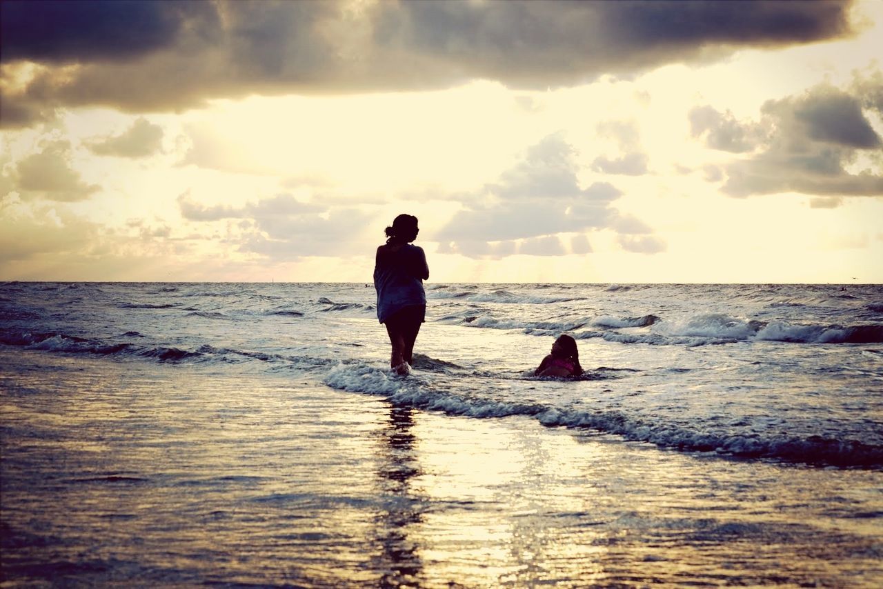 sea, horizon over water, water, beach, sky, sunset, shore, leisure activity, cloud - sky, full length, lifestyles, scenics, beauty in nature, standing, tranquil scene, rear view, tranquility, silhouette