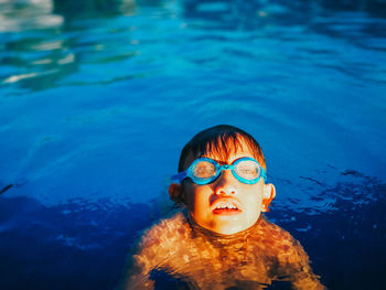 Boy swimming in pool