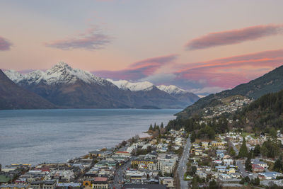 Scenic view of town against cloudy sky