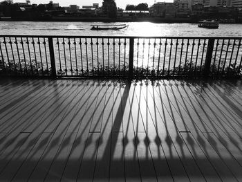 Shadow of railing on river