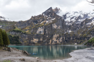 The view of oeschinenee lake and oeschinen valley amongst bernese alps mountain tops. 