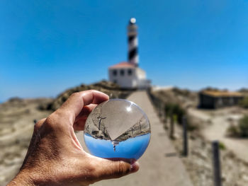 Close-up of hand holding crystal ball