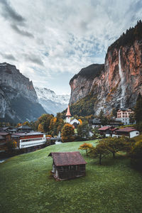 Scenic view of mountain range against cloudy sky