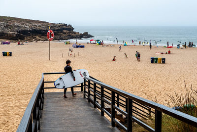 People on beach against sky