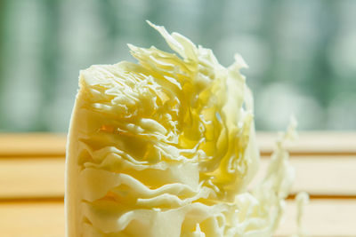 Close-up of yellow rose on table