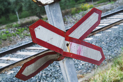 Close-up of stop sign on railroad track