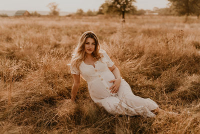 Young woman sitting on field