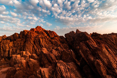 Rock formations on landscape against sky