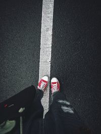 Low section of women standing on road