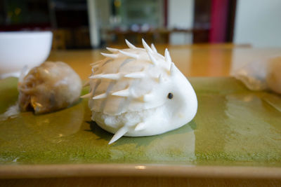 Close-up of a small chinese appetizer bao on a ceramic tray