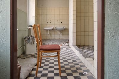 Empty chair in bathroom