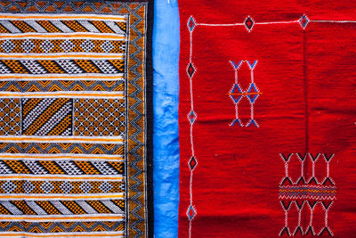 Close-up of moroccan traditional carpets hanged out on the wall in a bazaar. chefchaouen, morocco