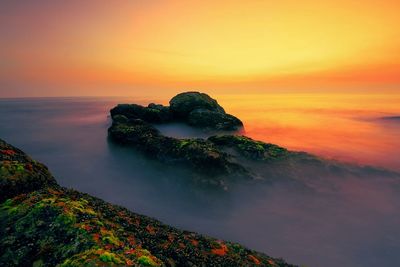 Scenic view of sea at sunset