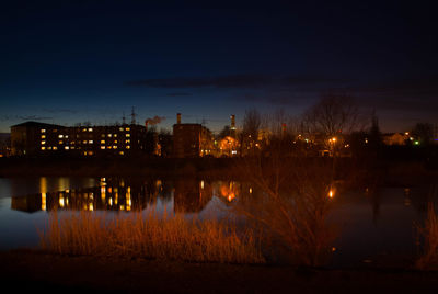 Illuminated buildings against sky at night